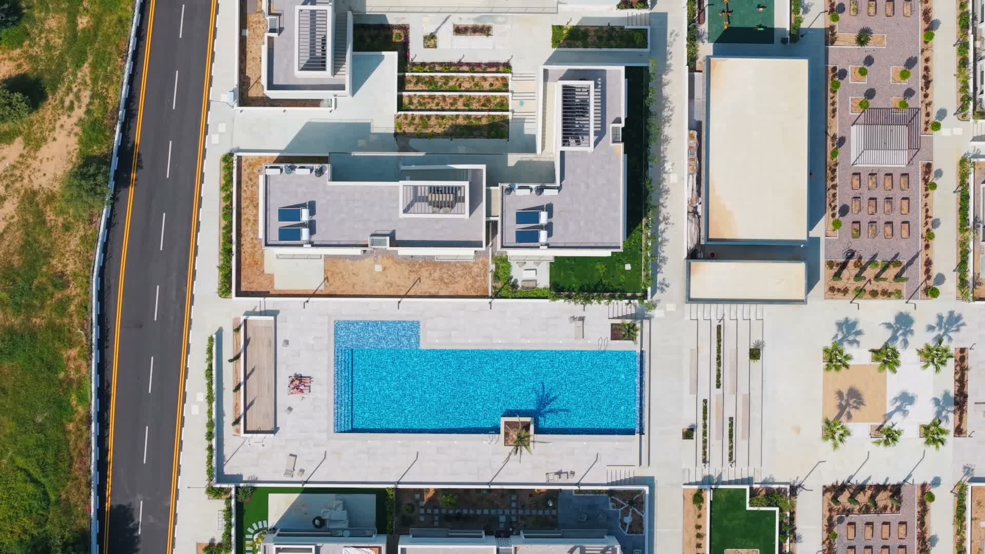 Aerial top-down view of the Mediterra complex with pools