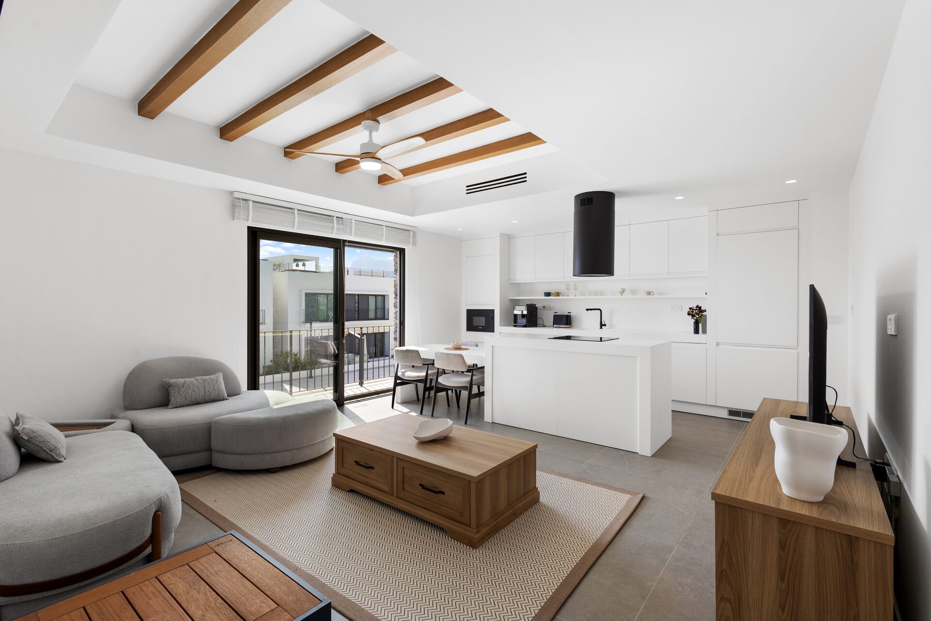 Open-plan living and dining with timber-beam ceiling